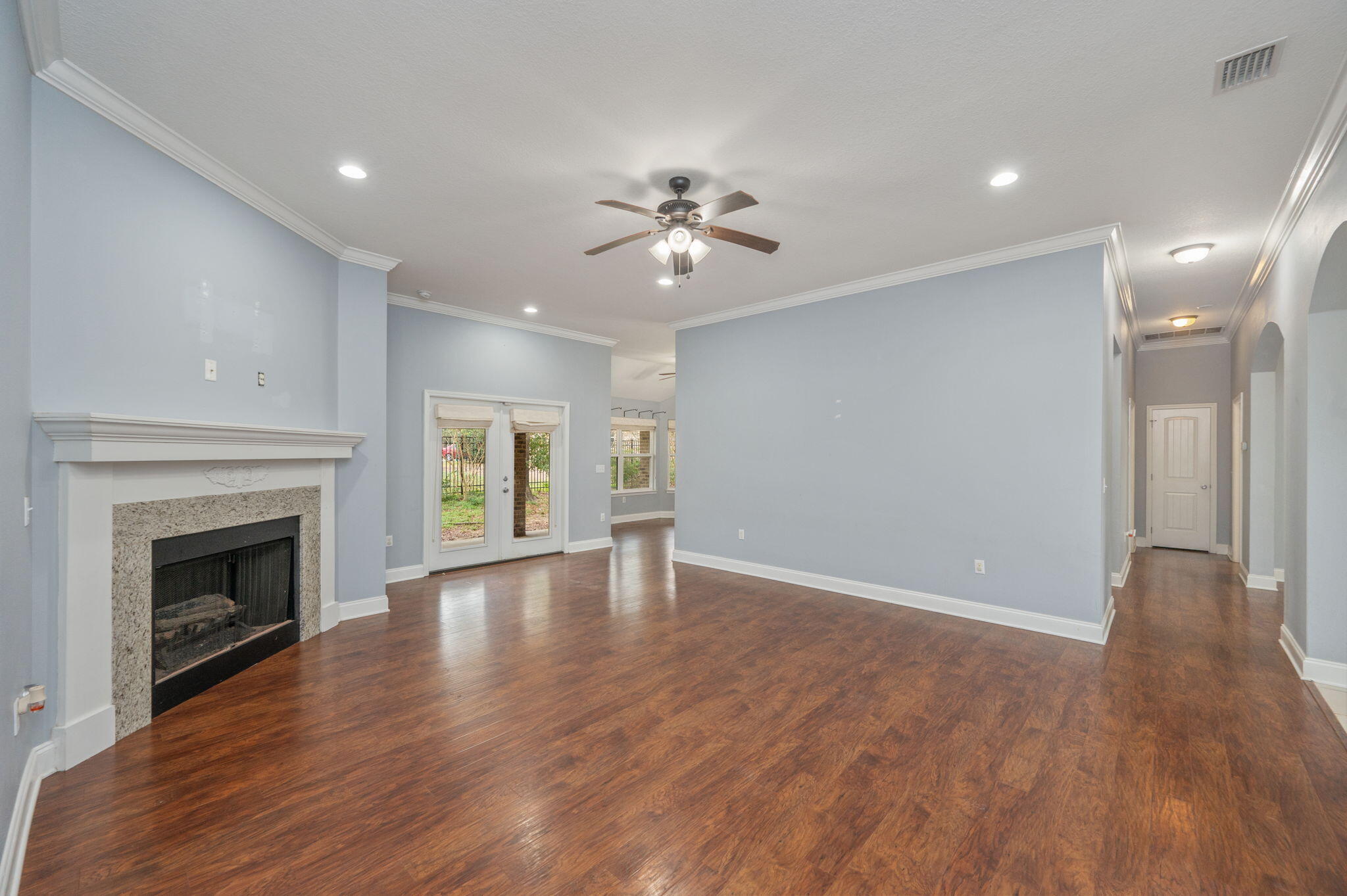 2909 Chancery Lane Crestview, FL 32539 - Photo 6 of 34 a view of an empty room with wooden floor fireplace and a window