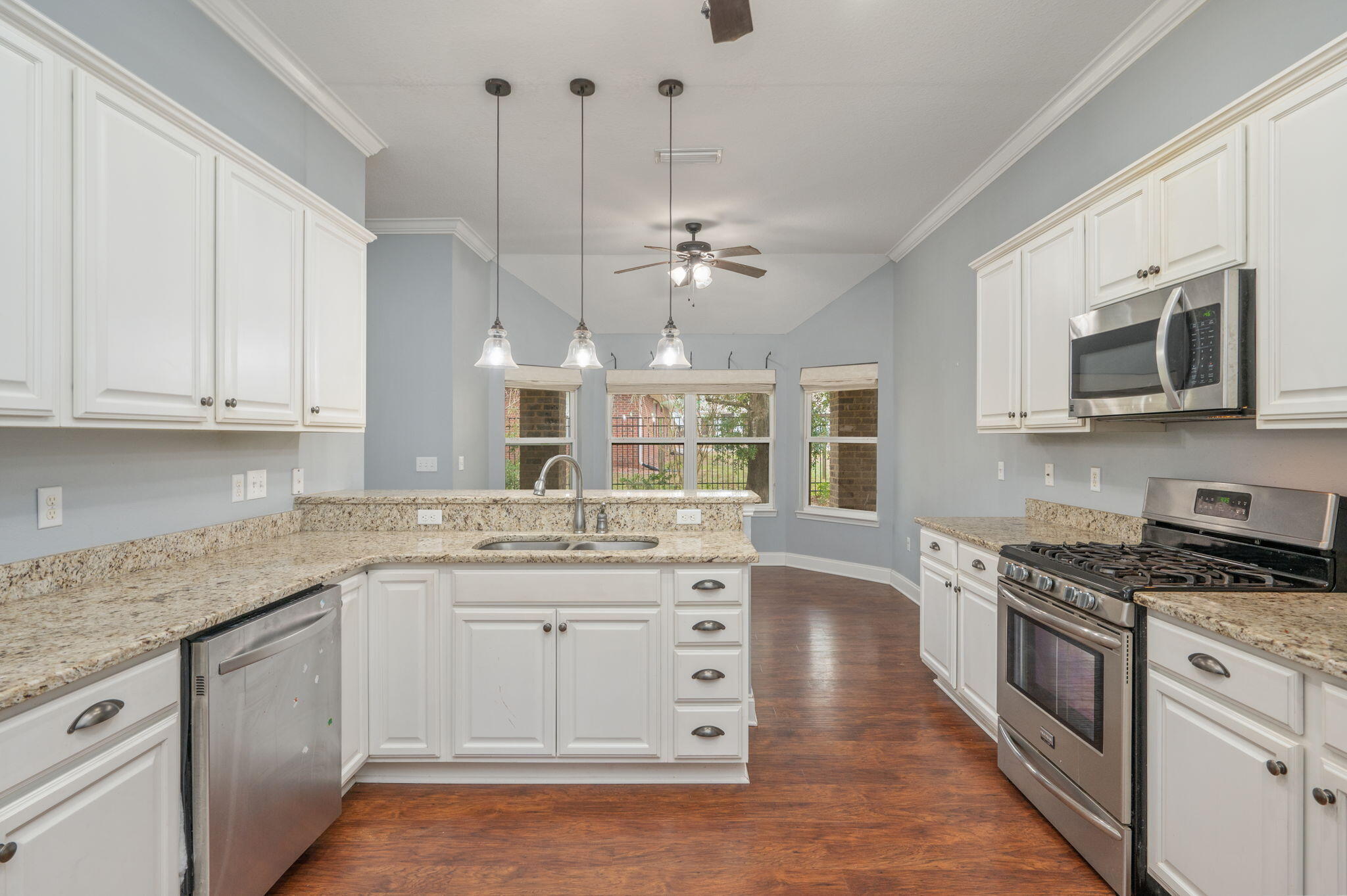 2909 Chancery Lane Crestview, FL 32539 - Photo 8 of 34 a kitchen with stainless steel appliances granite countertop a sink and dishwasher a stove top oven with white cabinets
