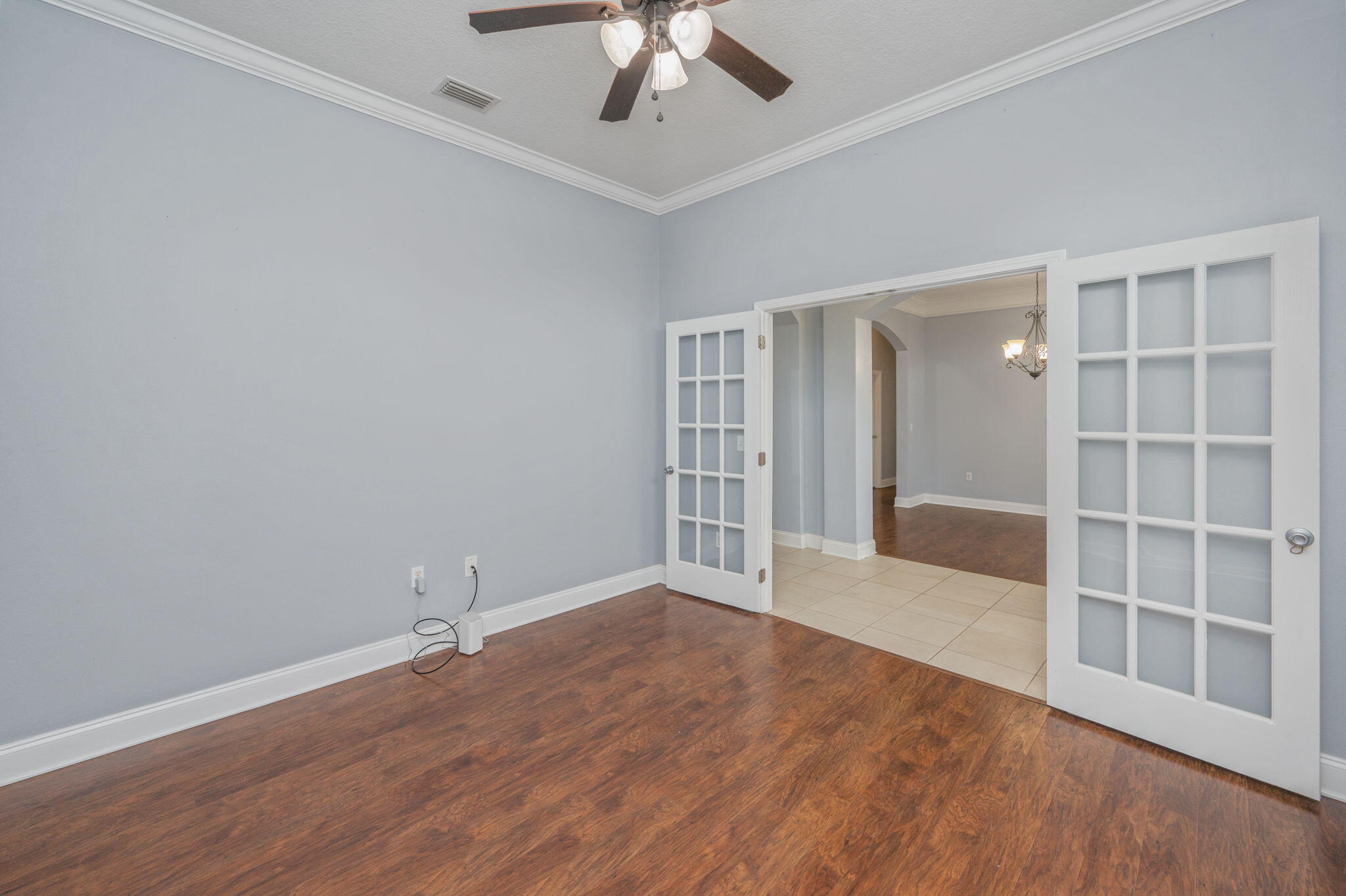 2909 Chancery Lane Crestview, FL 32539 - Photo 10 of 34 wooden floor in an empty room with a window
