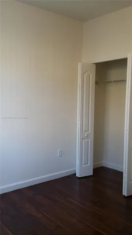 a front view of a house with a yard and palm trees