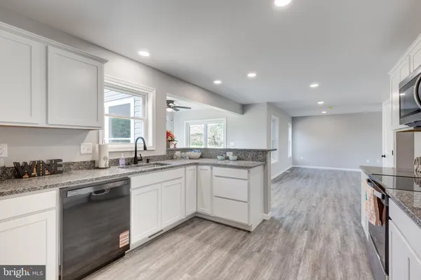 a kitchen with a sink stove and cabinets