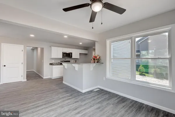 a view of kitchen with cabinets and wooden floor