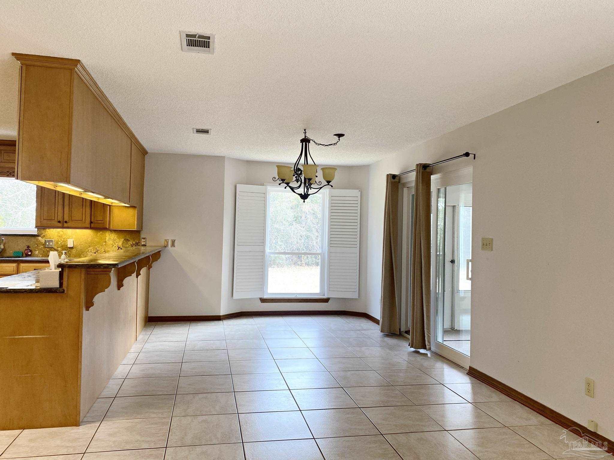 9141 Frank Pitman Road Milton, FL 32570 - Photo 18 of 51 a view of a kitchen with a sink and a refrigerator