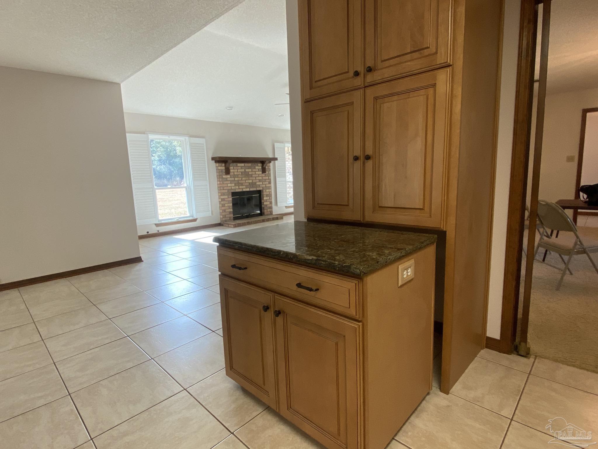 9141 Frank Pitman Road Milton, FL 32570 - Photo 25 of 51 a kitchen with granite countertop a sink cabinets and a refrigerator