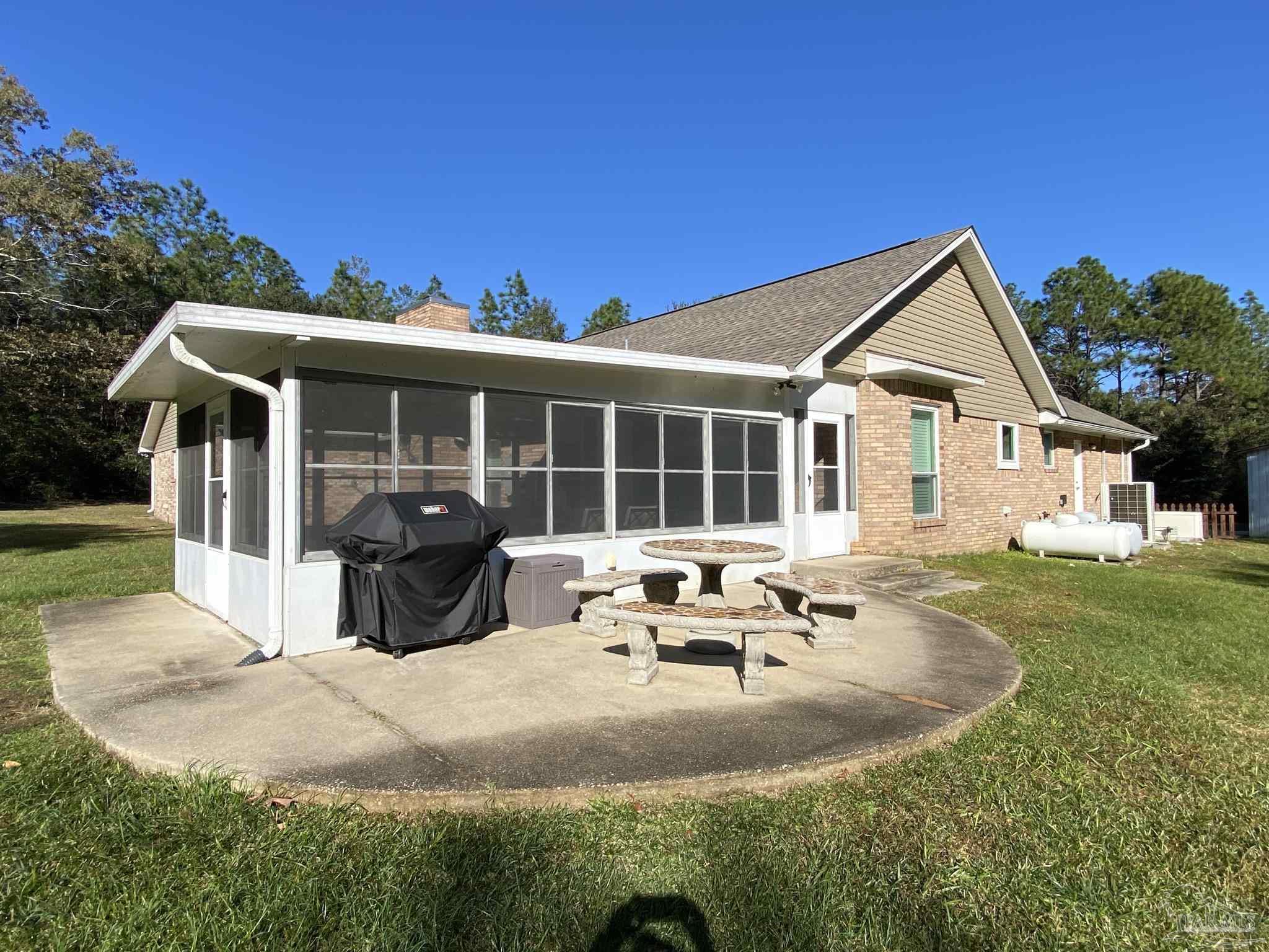 9141 Frank Pitman Road Milton, FL 32570 - Photo 3 of 51 a front view of a house with garden