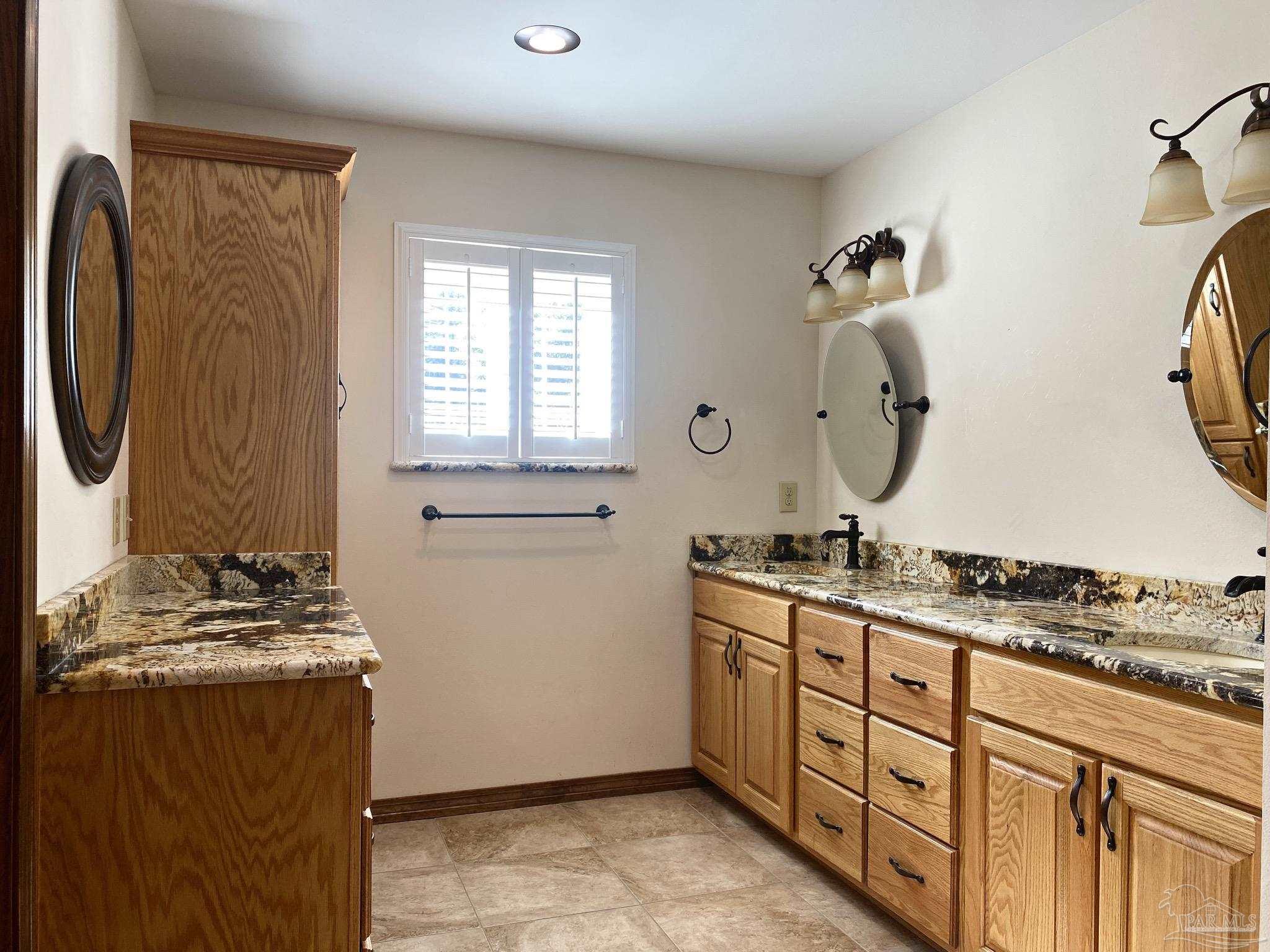 9141 Frank Pitman Road Milton, FL 32570 - Photo 35 of 51 a bathroom with a granite countertop sink and a mirror