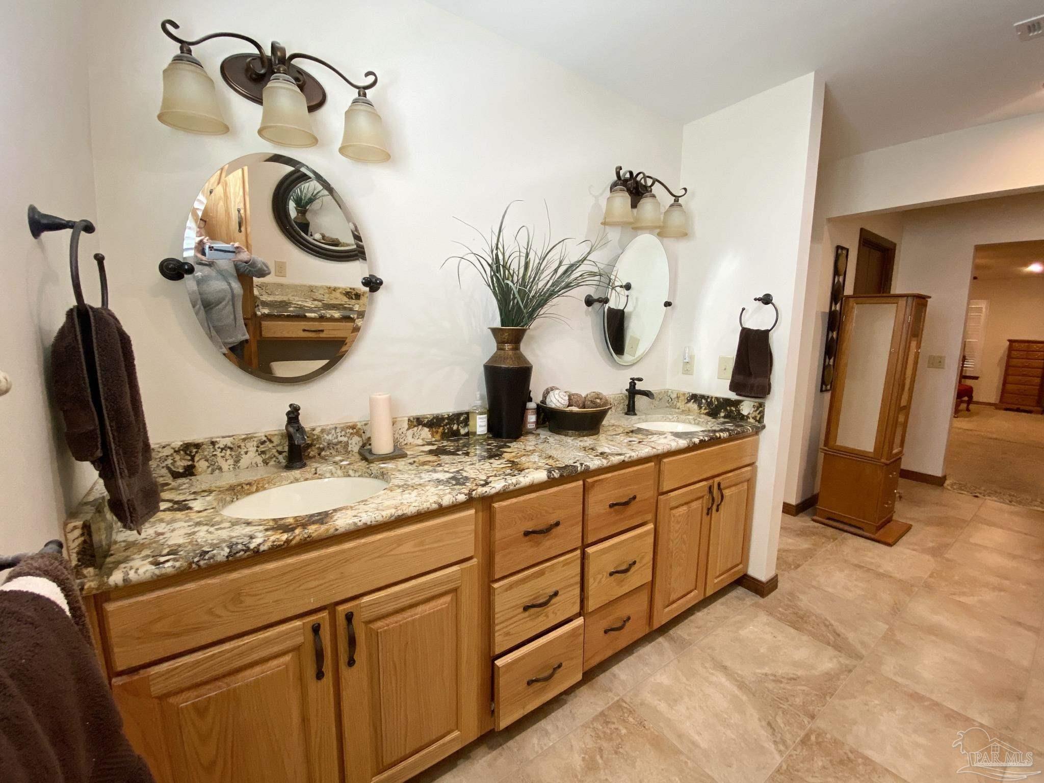 9141 Frank Pitman Road Milton, FL 32570 - Photo 37 of 51 a bathroom with a granite countertop sink and a mirror