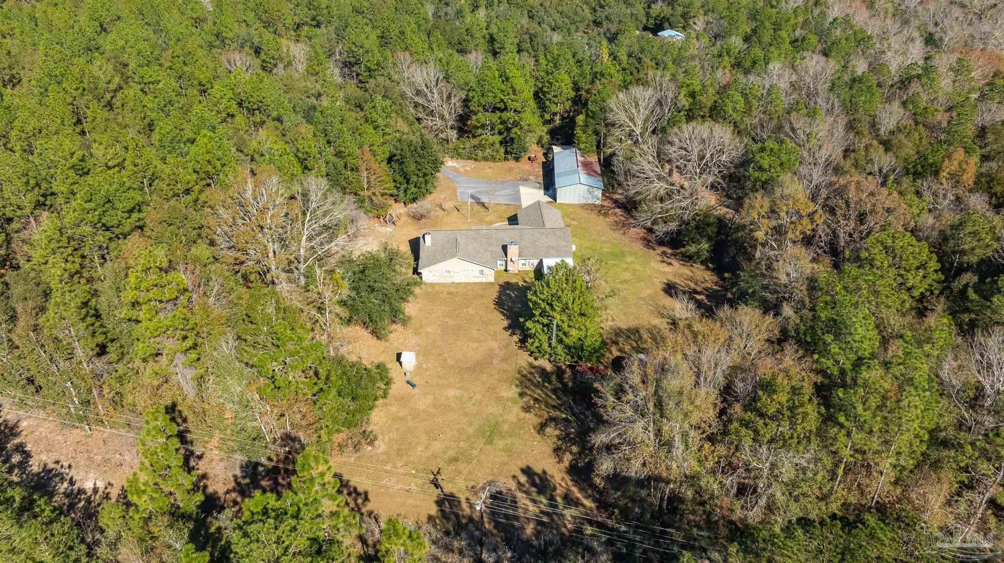 9141 Frank Pitman Road Milton, FL 32570 - Photo 51 of 51 a view of a lake with top of house