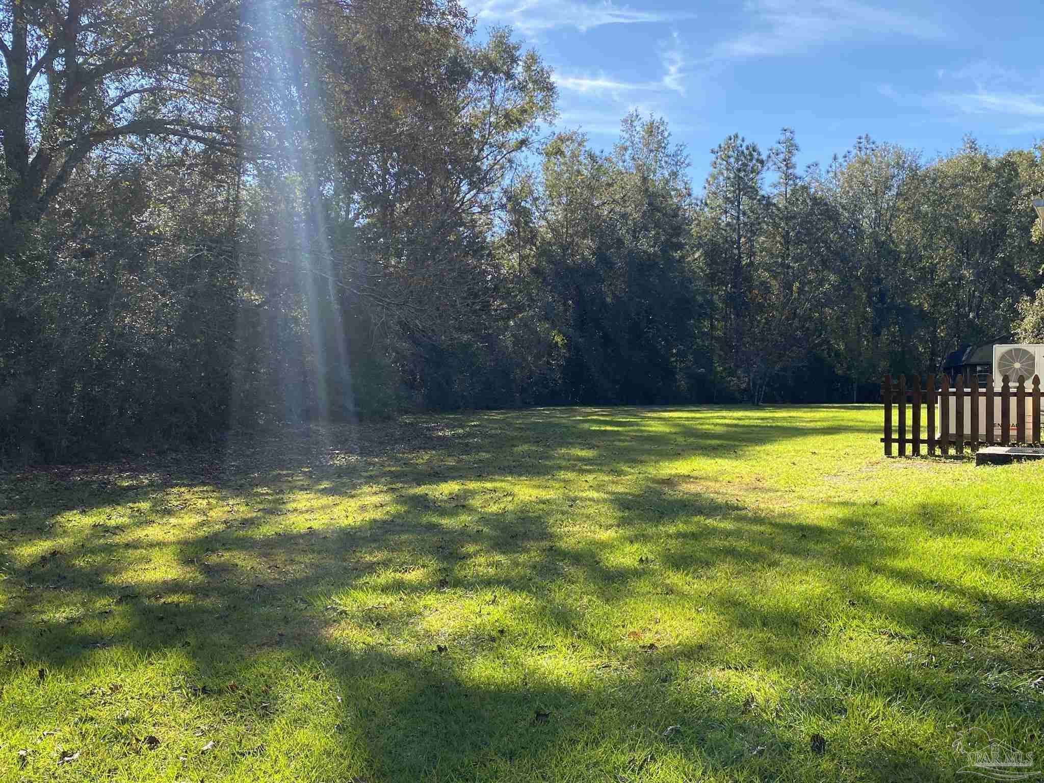 9141 Frank Pitman Road Milton, FL 32570 - Photo 8 of 51 a view of a swimming pool with a yard