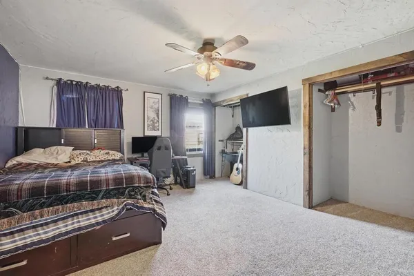 a bedroom with a bed and a chandelier