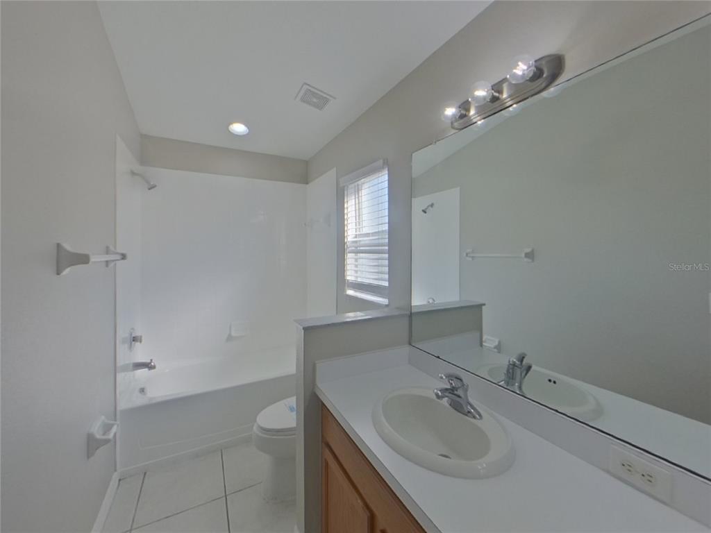Undisclosed Address Ruskin, FL 33570 - Photo 11 of 16 a bathroom with a sink double vanity and a mirror