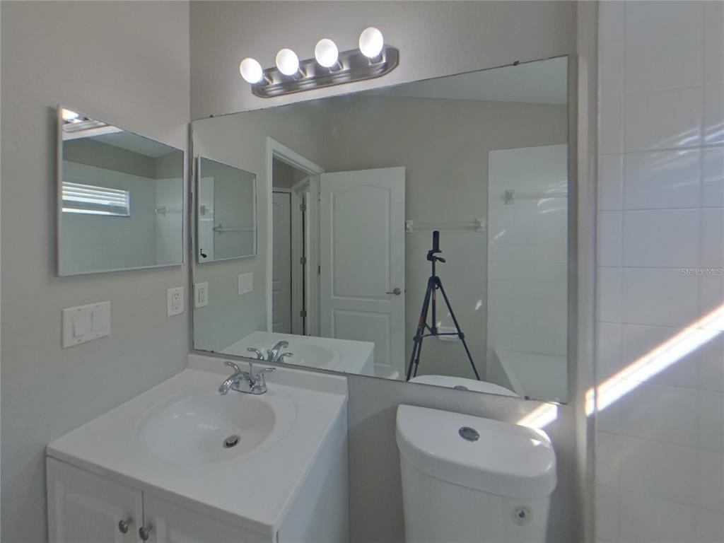 Undisclosed Address Ruskin, FL 33570 - Photo 14 of 16 a bathroom with a sink a mirror and a shower