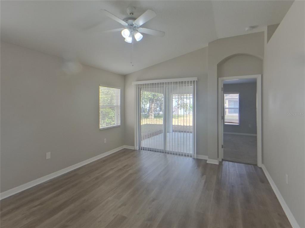 Undisclosed Address Ruskin, FL 33570 - Photo 3 of 16 wooden floor in an empty room with a window
