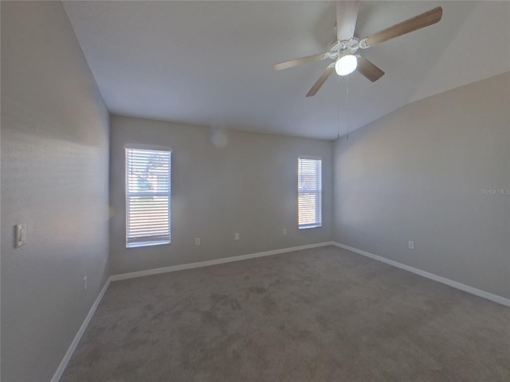 Undisclosed Address Ruskin, FL 33570 - Photo 8 of 16 an empty room with windows and fan