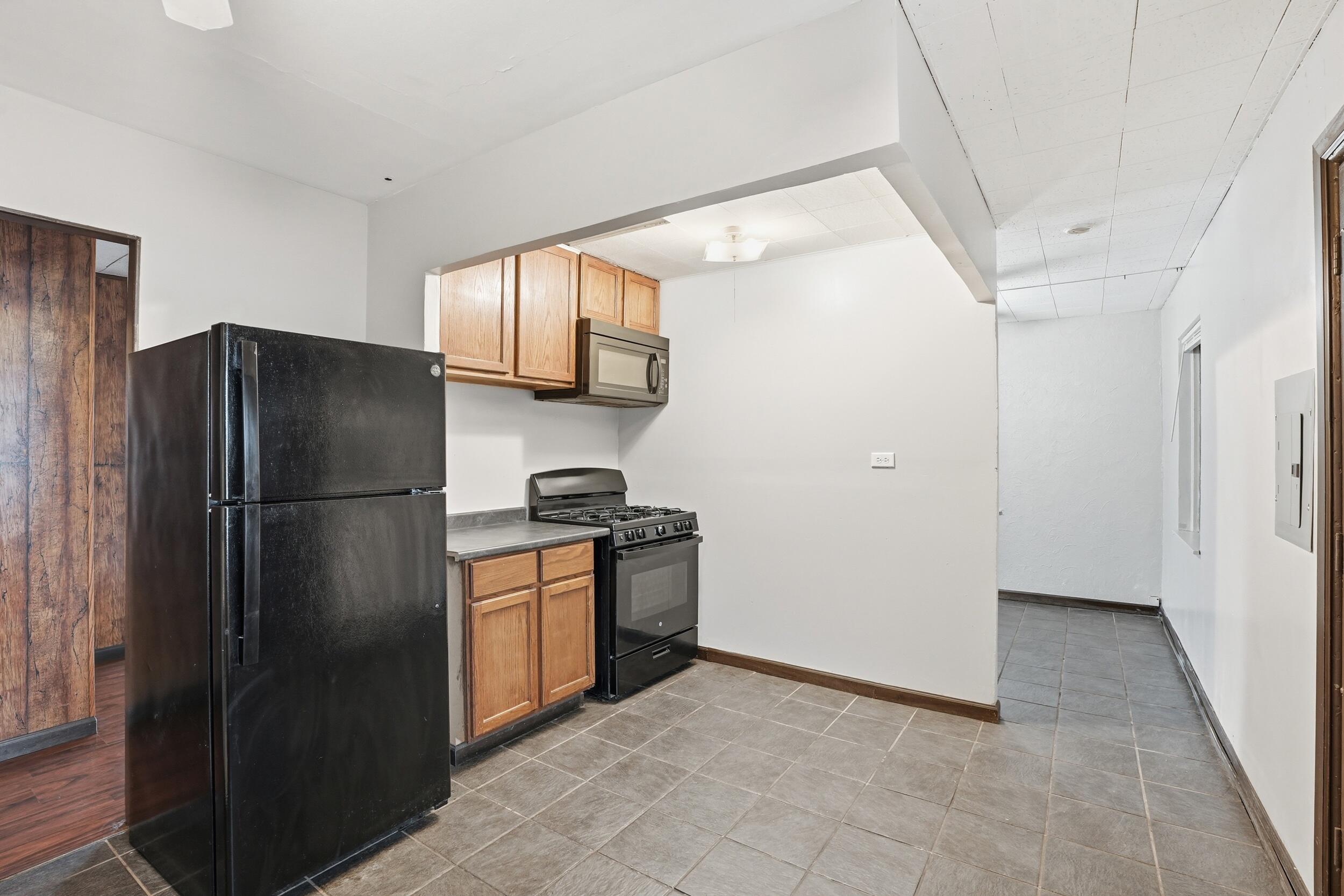 1620 180th Place Hammond, IN 46324 - Photo 12 of 19 a kitchen with stainless steel appliances granite countertop a refrigerator and a stove