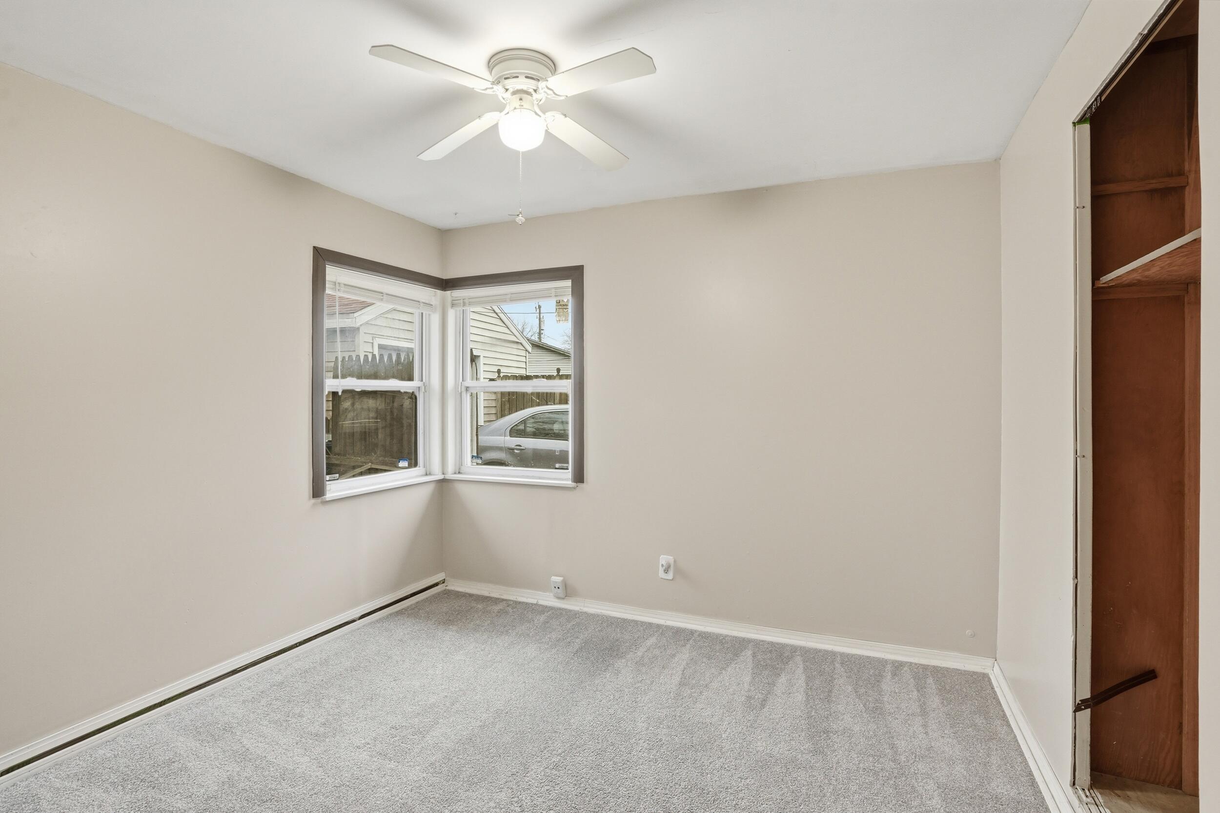 1620 180th Place Hammond, IN 46324 - Photo 13 of 19 an empty room with windows and fan