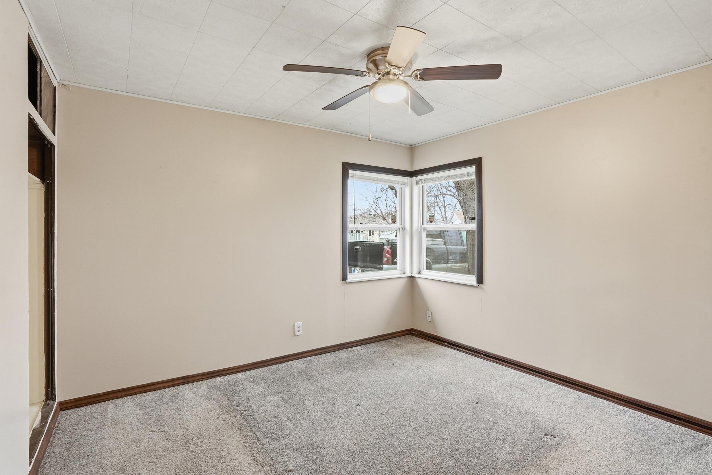 1620 180th Place Hammond, IN 46324 - Photo 14 of 19 an empty room with windows and fan