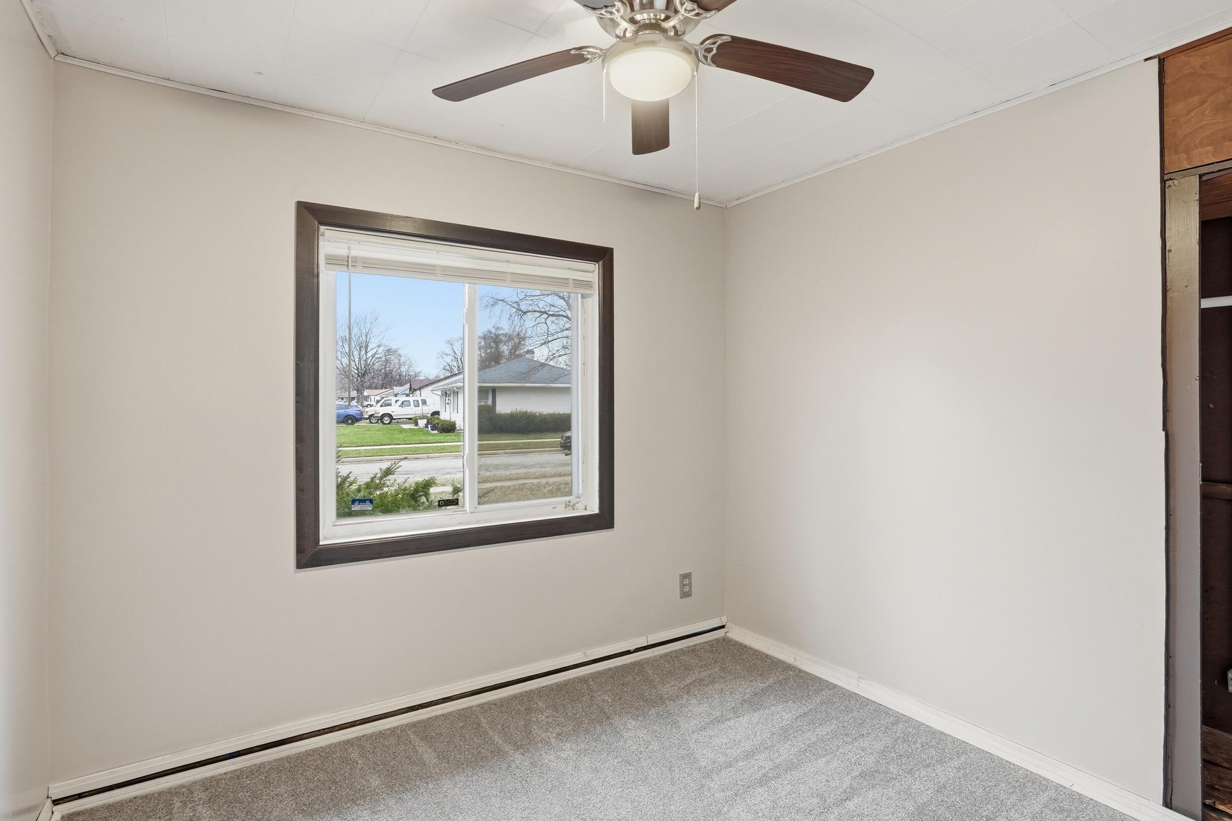 1620 180th Place Hammond, IN 46324 - Photo 15 of 19 an empty room with a window and a ceiling fan