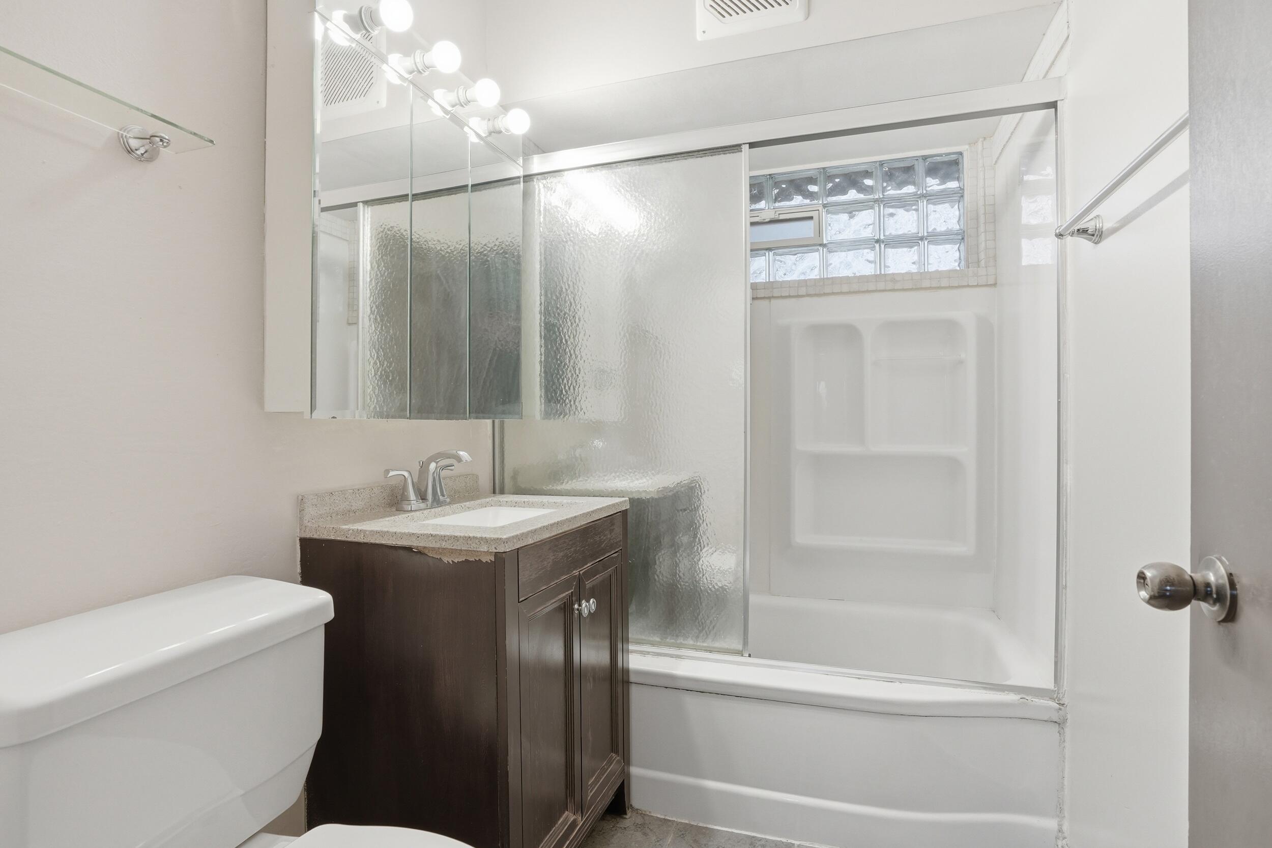 1620 180th Place Hammond, IN 46324 - Photo 16 of 19 a bathroom with a granite countertop sink toilet and shower