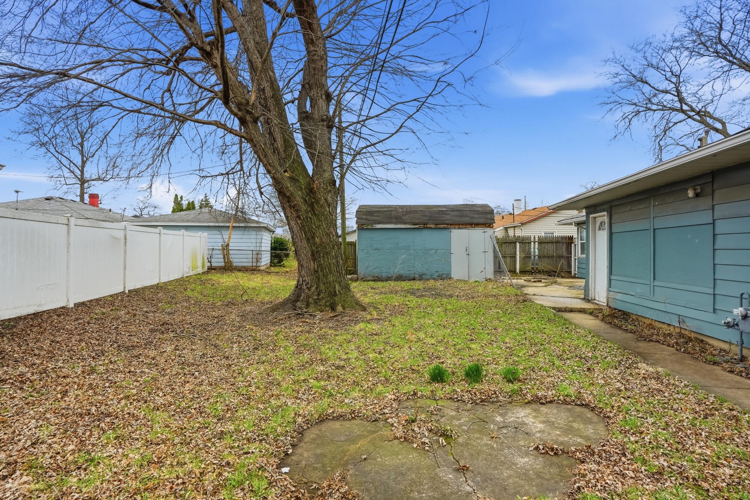 1620 180th Place Hammond, IN 46324 - Photo 19 of 19 a view of a house with a large tree and a yard