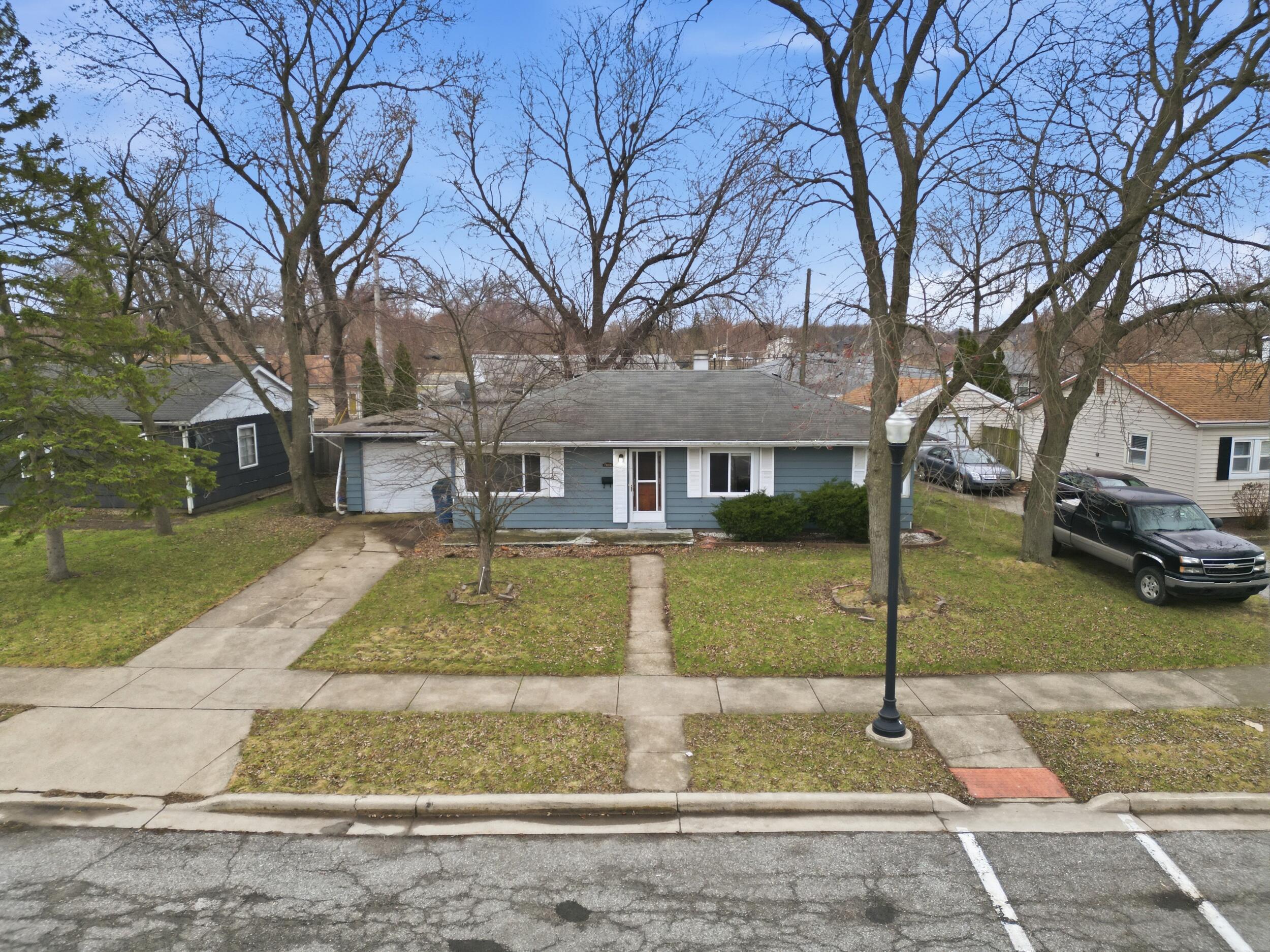 1620 180th Place Hammond, IN 46324 - Photo 4 of 19 a front view of a house with a yard