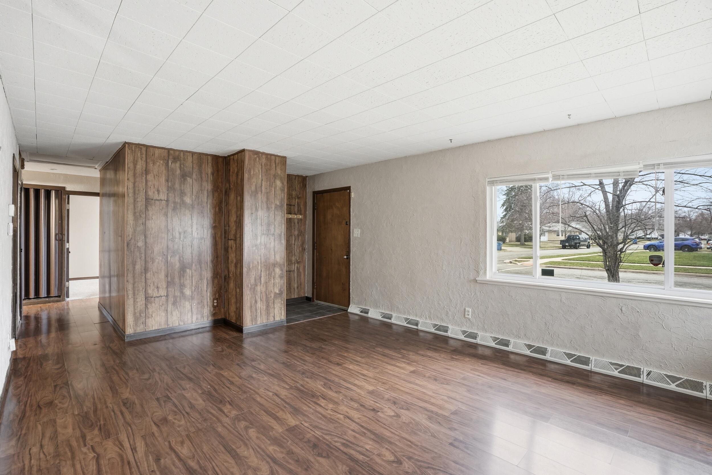 1620 180th Place Hammond, IN 46324 - Photo 6 of 19 an empty room with wooden floor and a window