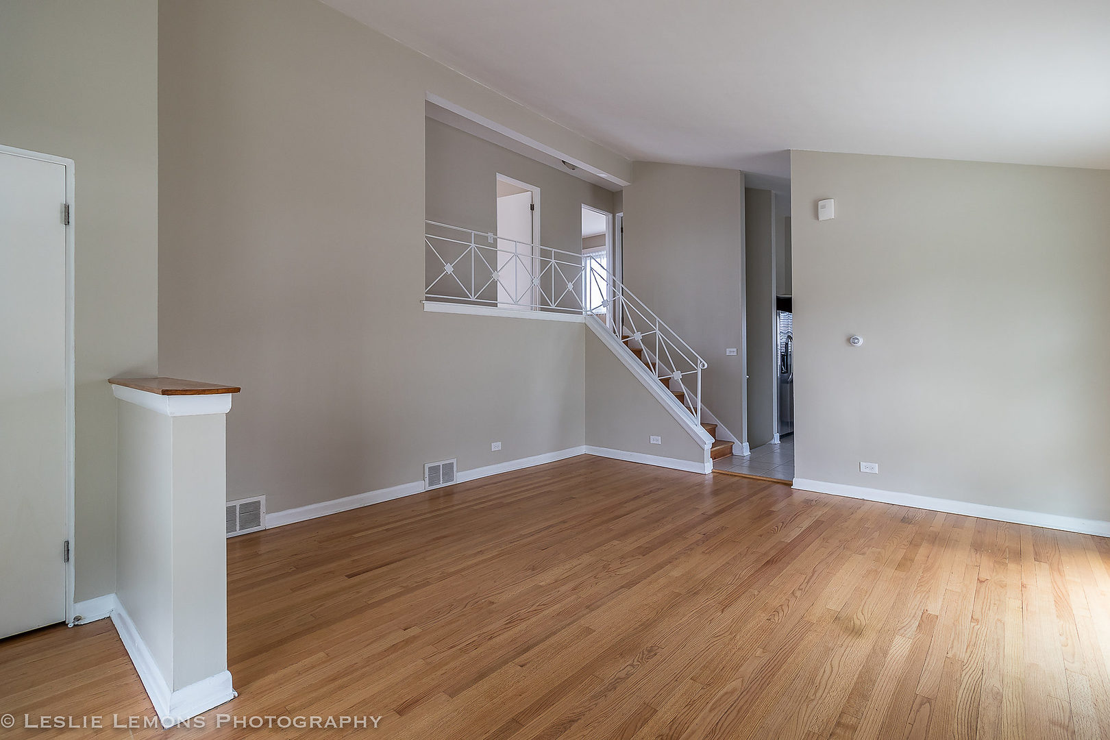 8541 North Shermer Road Niles, IL 60714 - Photo 2 of 26 a view of an empty room with wooden floor and a window