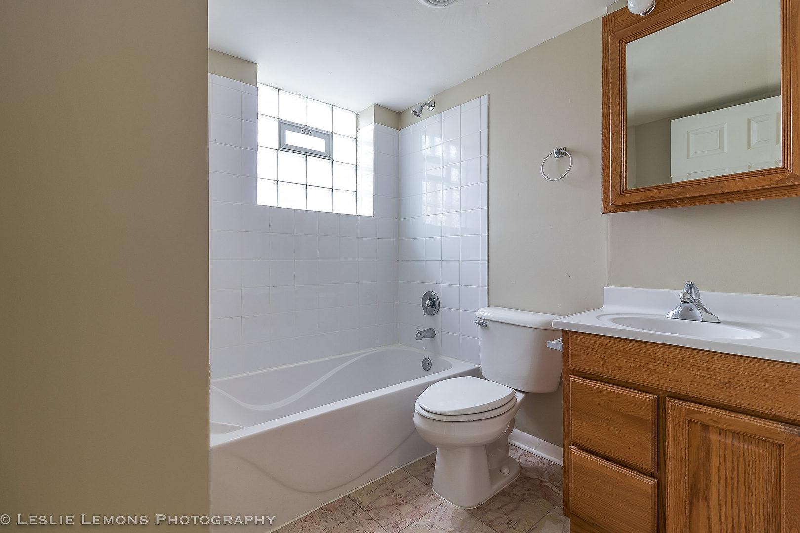 8541 North Shermer Road Niles, IL 60714 - Photo 11 of 26 a bathroom with a granite countertop toilet a sink and bathtub