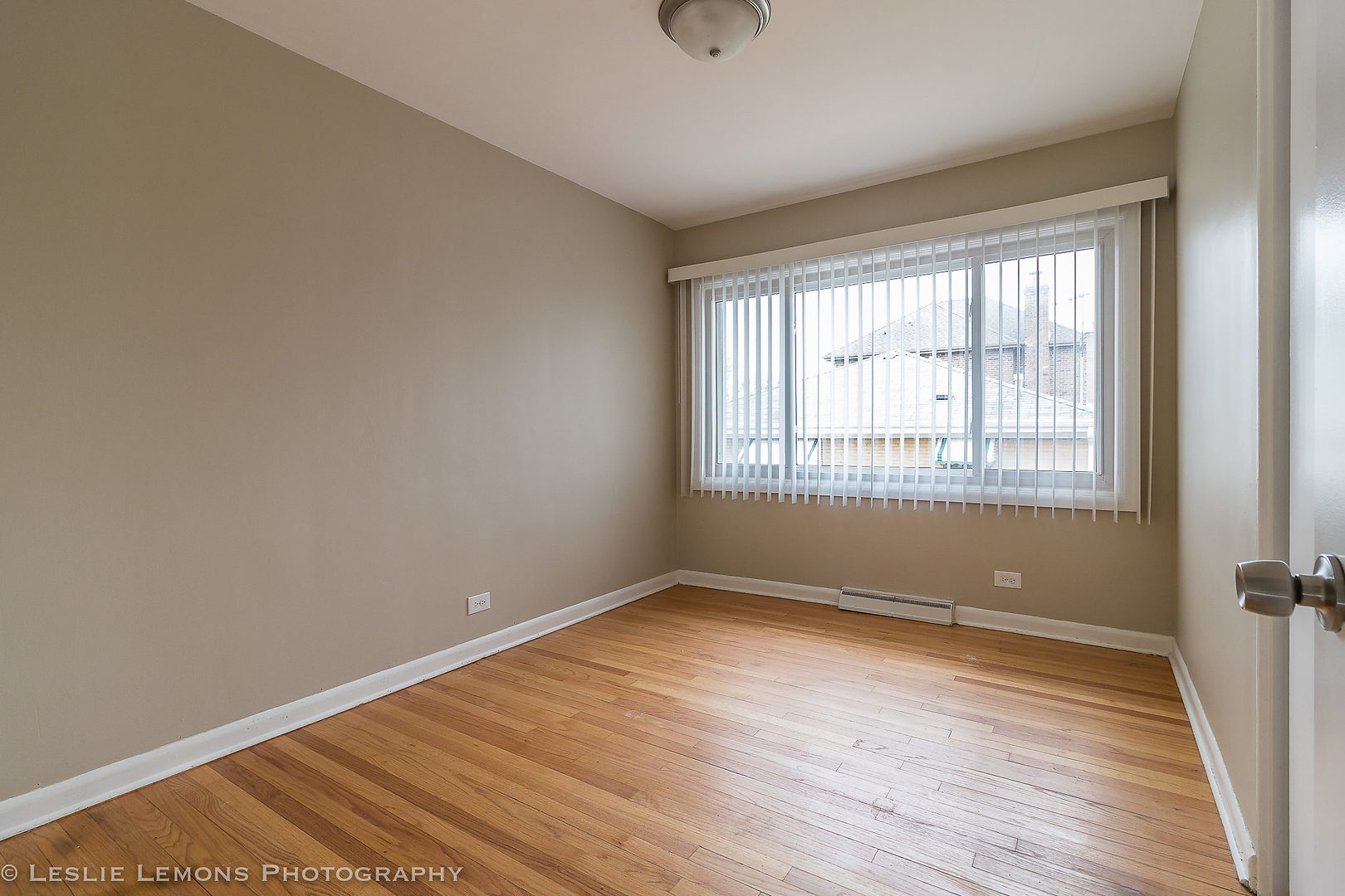 8541 North Shermer Road Niles, IL 60714 - Photo 15 of 26 an empty room with wooden floor and windows