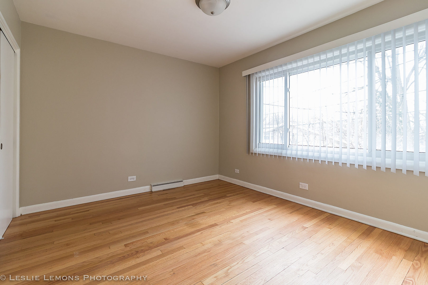 8541 North Shermer Road Niles, IL 60714 - Photo 17 of 26 a view of an empty room with wooden floor and a window