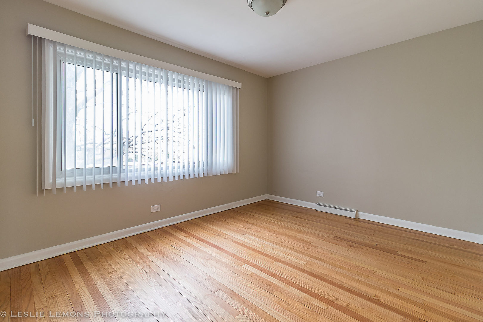 8541 North Shermer Road Niles, IL 60714 - Photo 19 of 26 a view of an empty room with wooden floor and a window