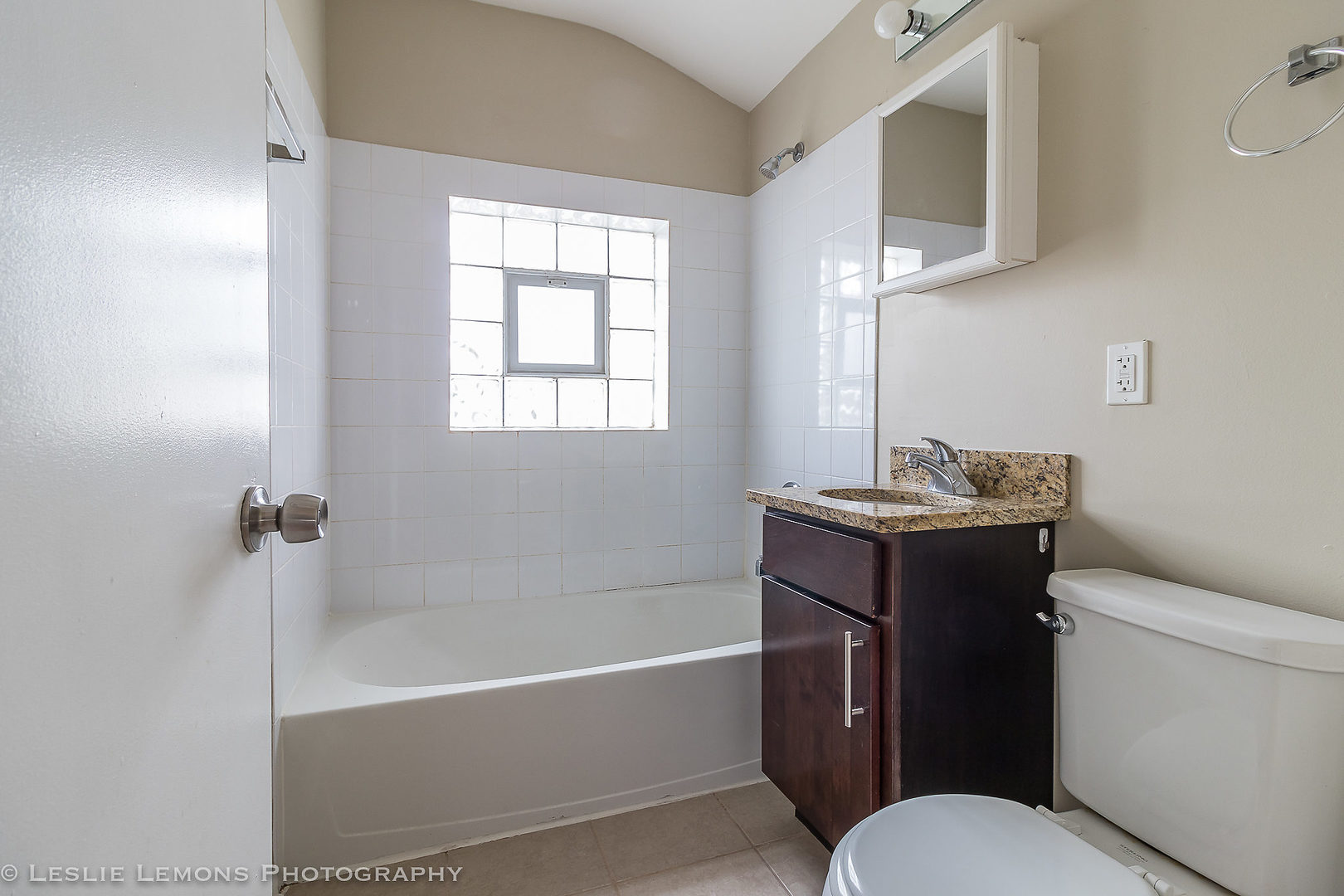 8541 North Shermer Road Niles, IL 60714 - Photo 23 of 26 a bathroom with a granite countertop toilet sink and bathtub