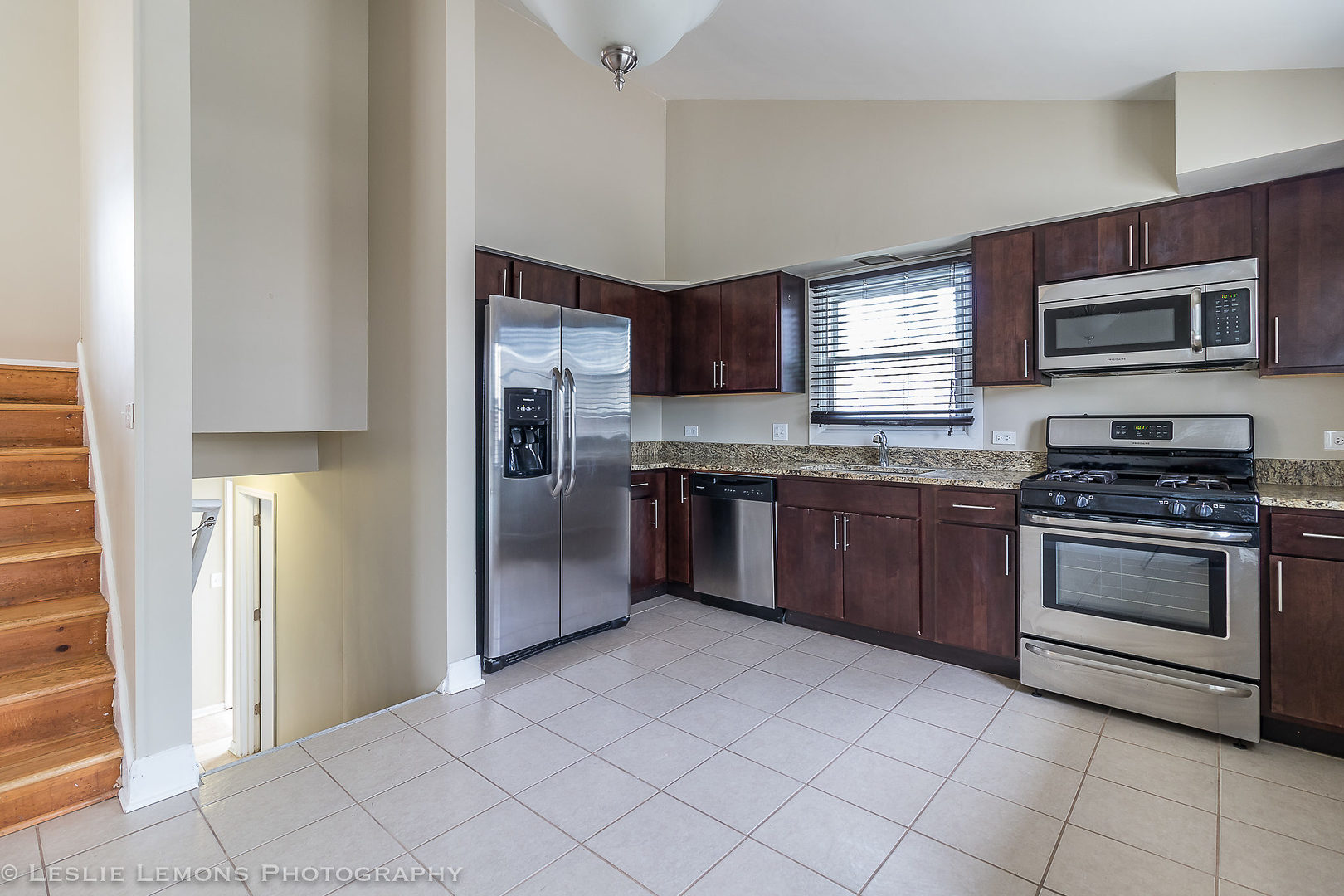 8541 North Shermer Road Niles, IL 60714 - Photo 6 of 26 a kitchen with stainless steel appliances granite countertop a stove a sink and a refrigerator