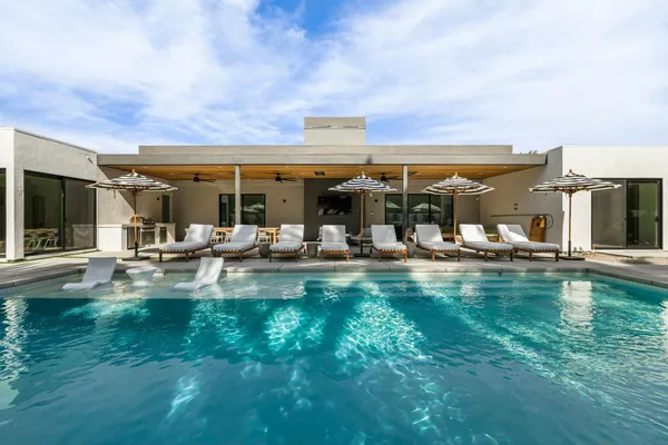 a view of swimming pool with outdoor seating