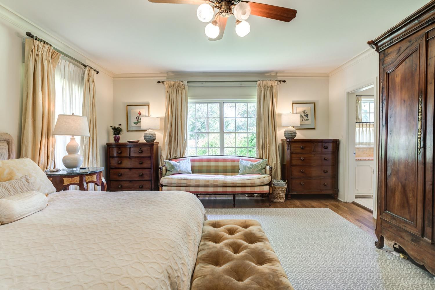 4909 19th Street Lubbock, TX 79407 - Photo 15 of 50 a bedroom with a bed and a chandelier