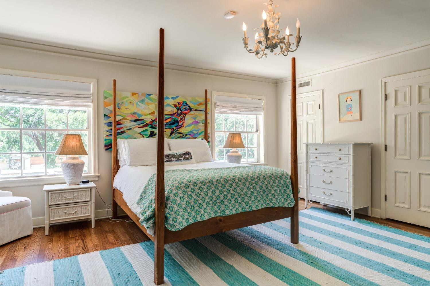 4909 19th Street Lubbock, TX 79407 - Photo 33 of 50 a bedroom with a bed chandelier and a window