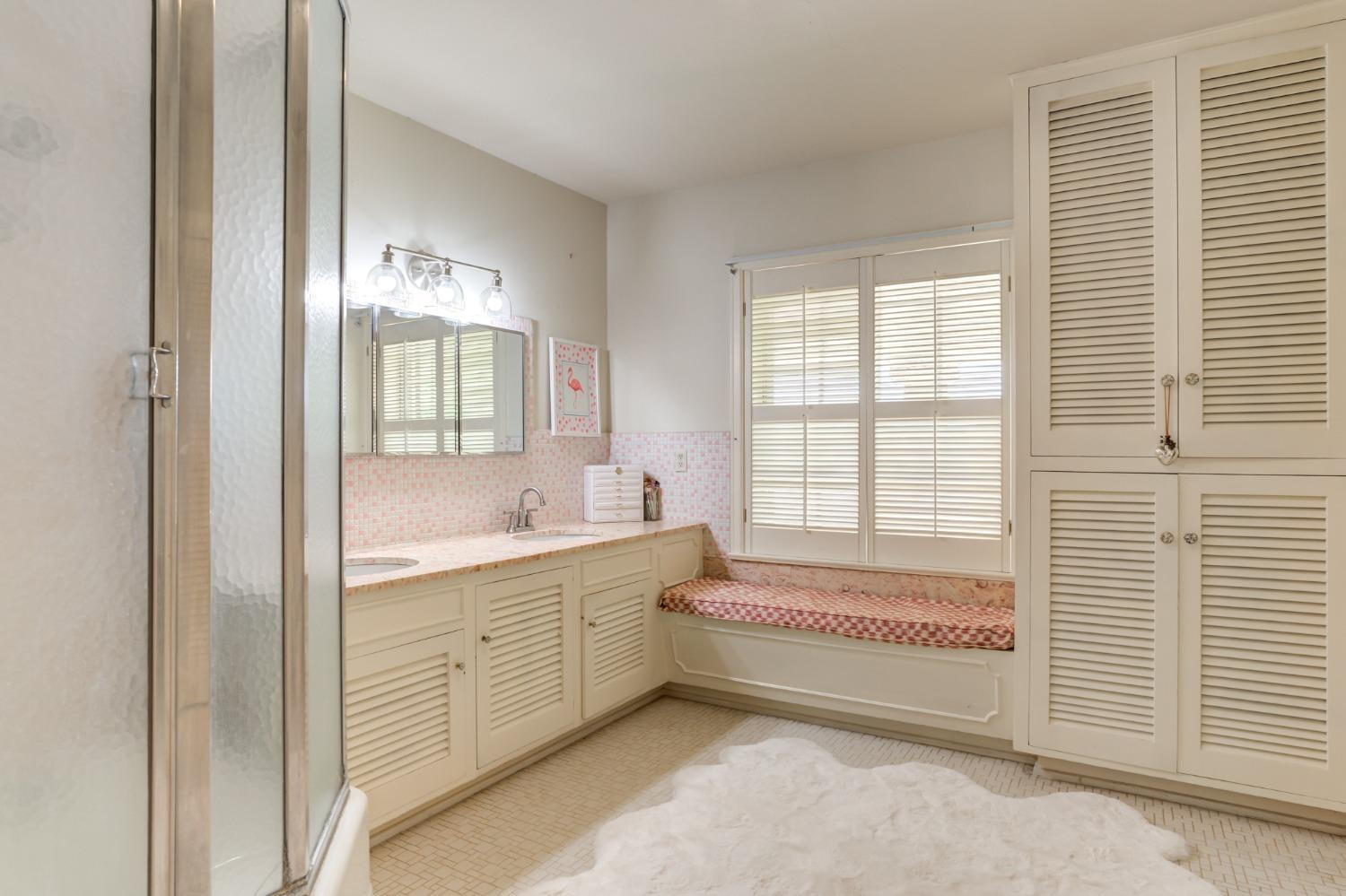 4909 19th Street Lubbock, TX 79407 - Photo 34 of 50 a bathroom with a tub sink and mirror