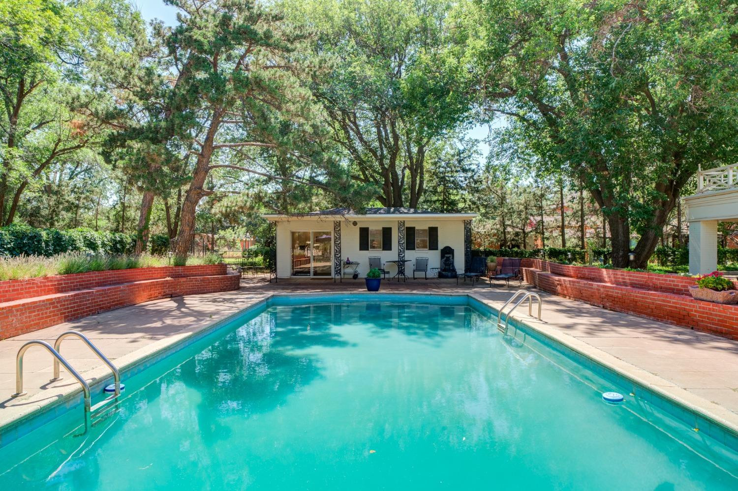 4909 19th Street Lubbock, TX 79407 - Photo 41 of 50 a view of a yard with plants and large trees
