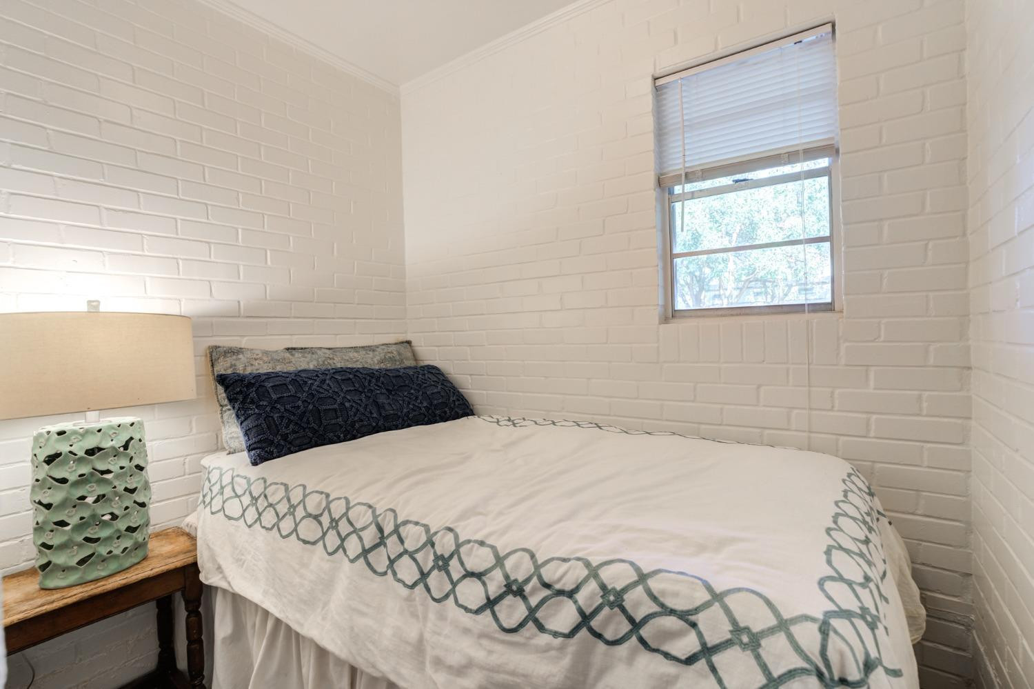 4909 19th Street Lubbock, TX 79407 - Photo 44 of 50 a bedroom with a bed and a window