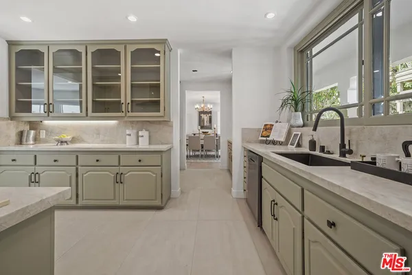 a spacious en suite bathroom with a granite countertop sink mirror and window