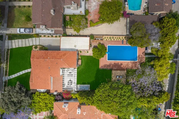 an aerial view of a house with outdoor space and street view