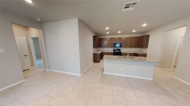 a view of kitchen with stainless steel appliances cabinets