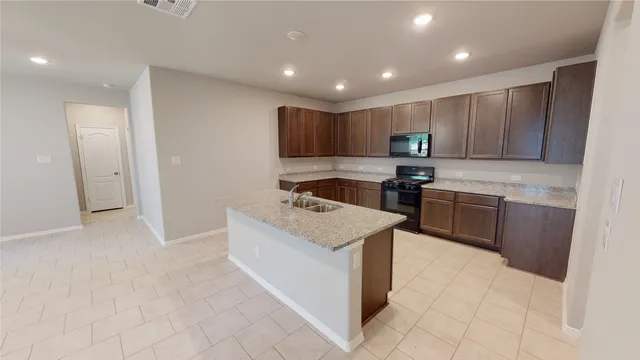 a kitchen with a stove top oven and cabinets
