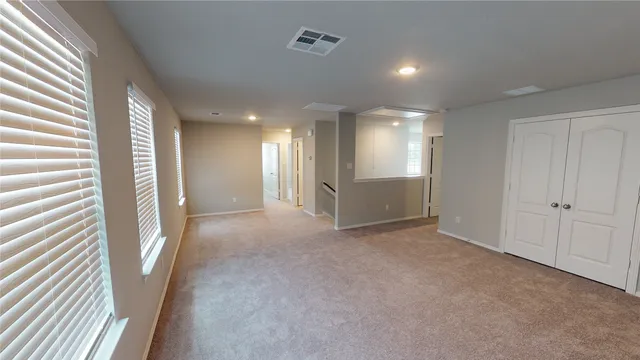 a view of a big room with windows and brick walls