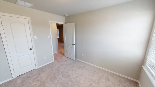 an empty room with closet and wooden floor