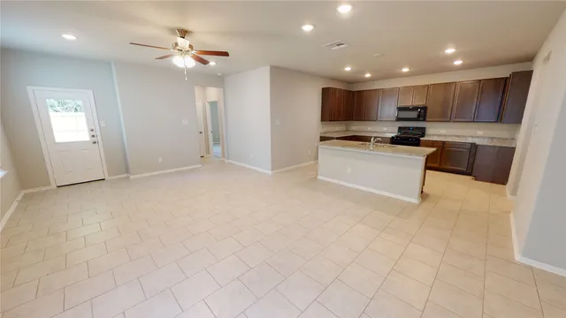 a view of kitchen with stainless steel appliances refrigerator oven and cabinets