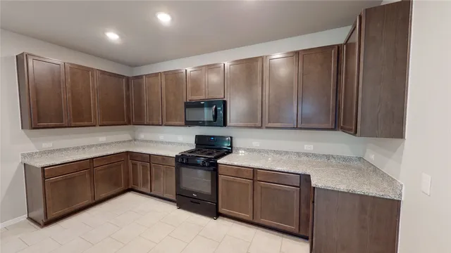 a kitchen with cabinets a sink and stainless steel appliances