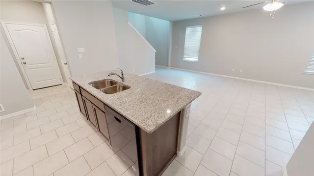 a kitchen with a sink a microwave and cabinets
