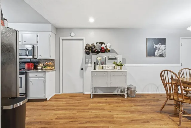 a view of kitchen with furniture and wooden floor