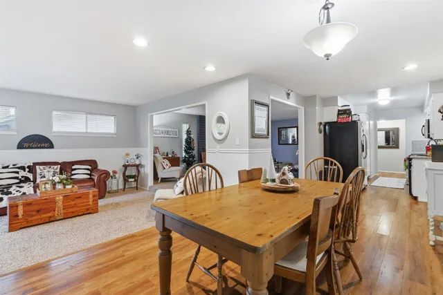 a view of a dining room with furniture and wooden floor
